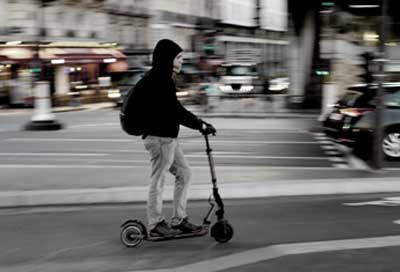 Un jeune homme sur une trottinette dans Paris